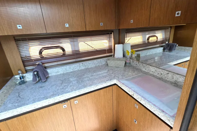 Slide: The Image of Luxurious 2018 Sea Ray Sundancer 510 yacht interior with sleek wooden cabinetry and granite countertops. - 45