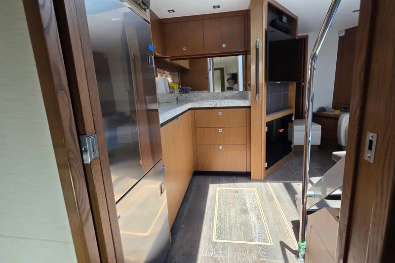 Slide: The Image of Interior of 2018 Sea Ray Sundancer 510 yacht with modern kitchen and wood finishes. - 46