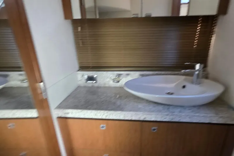 Slide: The Image of Luxurious bathroom interior of 2018 Sea Ray Sundancer 510 yacht with modern sink and wooden cabinetry. - 47