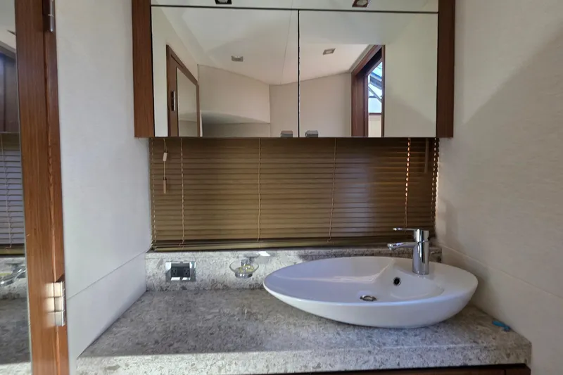 Slide: The Image of Luxurious bathroom vanity in 2018 Sea Ray Sundancer 510 yacht, featuring modern sink and mirror. - 48