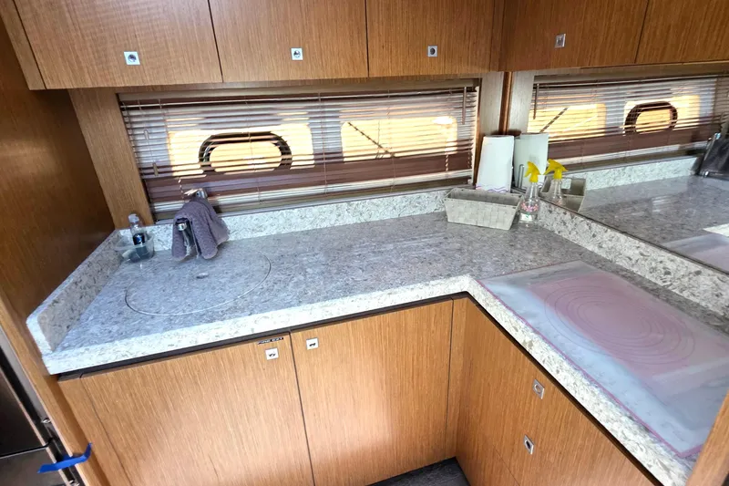 Slide: The Image of Luxurious 2018 Sea Ray Sundancer 510 yacht interior with sleek wooden cabinetry and granite countertops. - 57