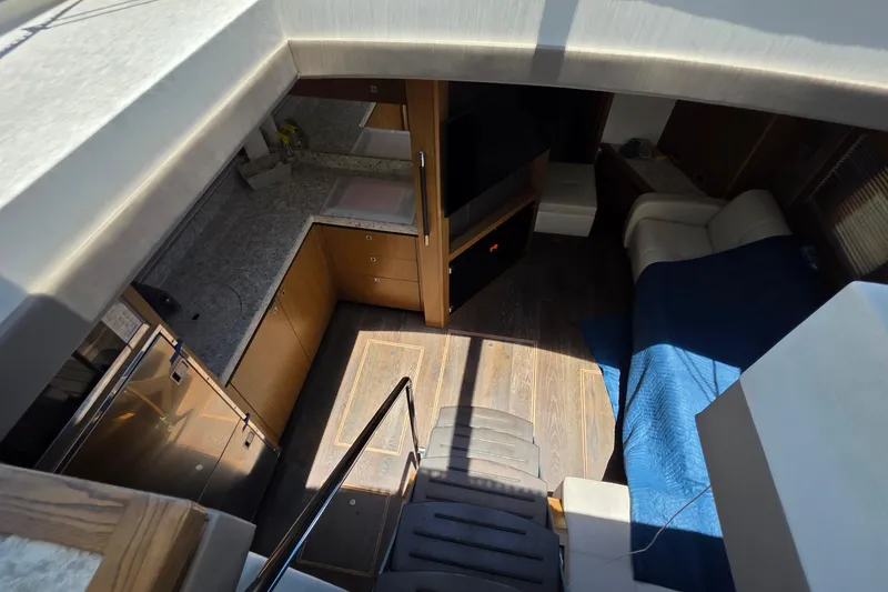 Slide: The Image of Interior view of 2018 Sea Ray Sundancer 510 yacht, featuring modern kitchen and cozy seating area. - 59