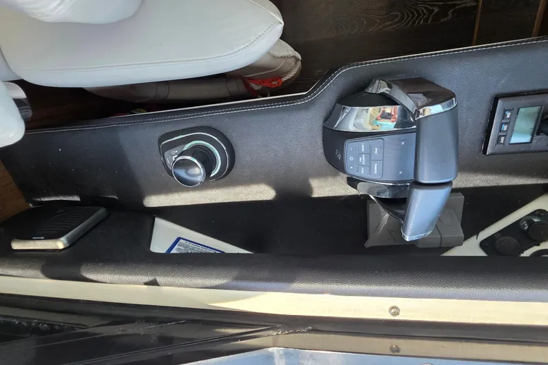Slide: The Image of 2018 Sea Ray Sundancer 510 helm controls with throttle and steering wheel. - 60