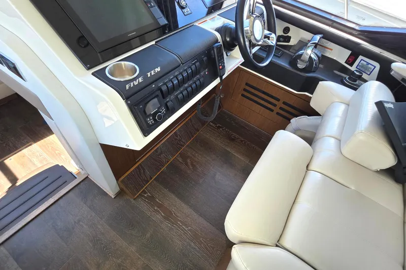 Slide: The Image of 2018 Sea Ray Sundancer 510 helm with leather seating and modern controls. - 61
