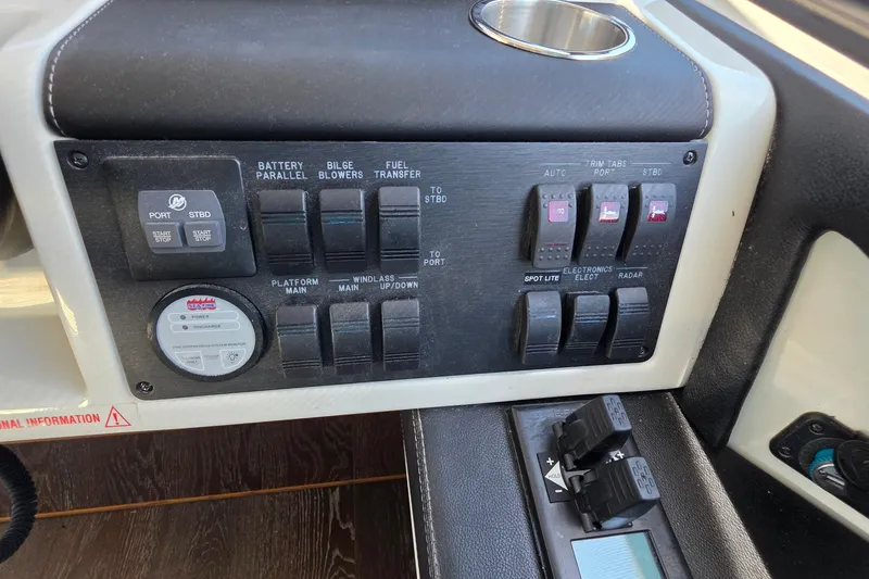 Slide: The Image of Control panel of a 2018 Sea Ray Sundancer 510 yacht with various switches and indicators. - 62