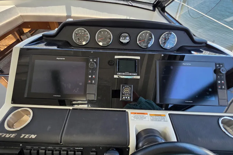 Slide: The Image of 2018 Sea Ray Sundancer 510 helm with dual Raymarine displays and gauges. - 63