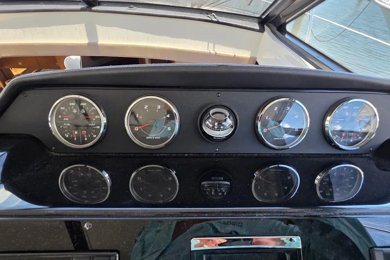 Slide: The Image of Dashboard of a 2018 Sea Ray Sundancer 510 with gauges and compass. - 64
