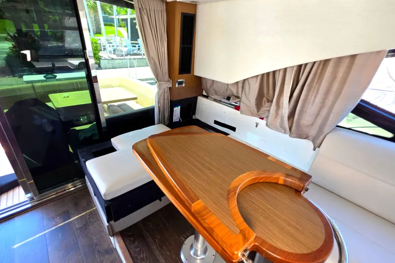 Slide: The Image of Luxurious interior of 2018 Sea Ray Sundancer 510 yacht with elegant wood table and seating. - 66
