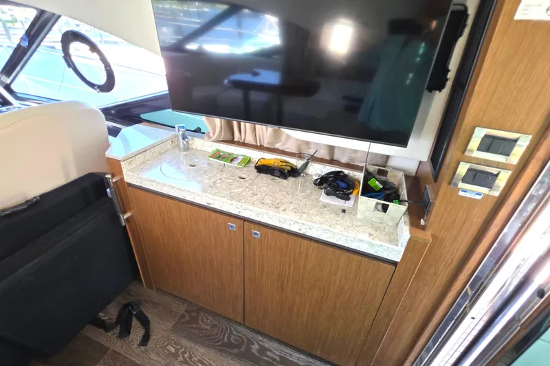 Slide: The Image of Interior of 2018 Sea Ray Sundancer 510 yacht with TV and countertop amenities. - 69