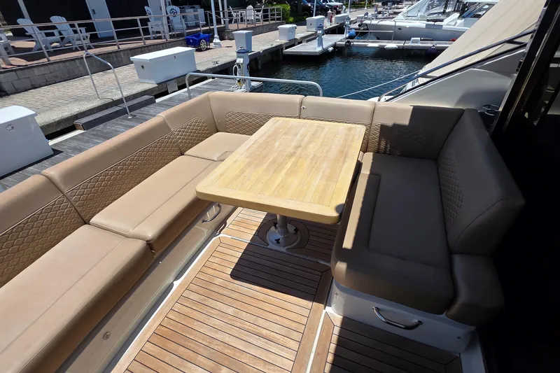 Slide: The Image of Luxurious seating area on 2018 Sea Ray Sundancer 510 yacht with wooden table. - 74