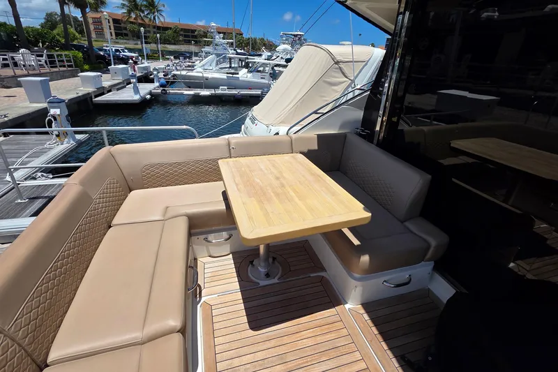 Slide: The Image of Luxurious 2018 Sea Ray Sundancer 510 yacht with elegant outdoor seating and wooden table. - 75