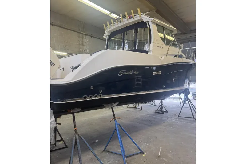 Slide: The Image of 2005 Seaswirl Striper 2901 Walkaround Alaska Pkg boat in a workshop on stands. - 1