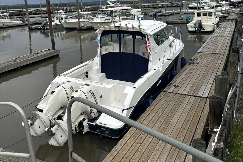 Slide: The Image of 2005 Seaswirl Striper 2901 Walkaround Alaska Pkg docked at marina with twin engines. - 2