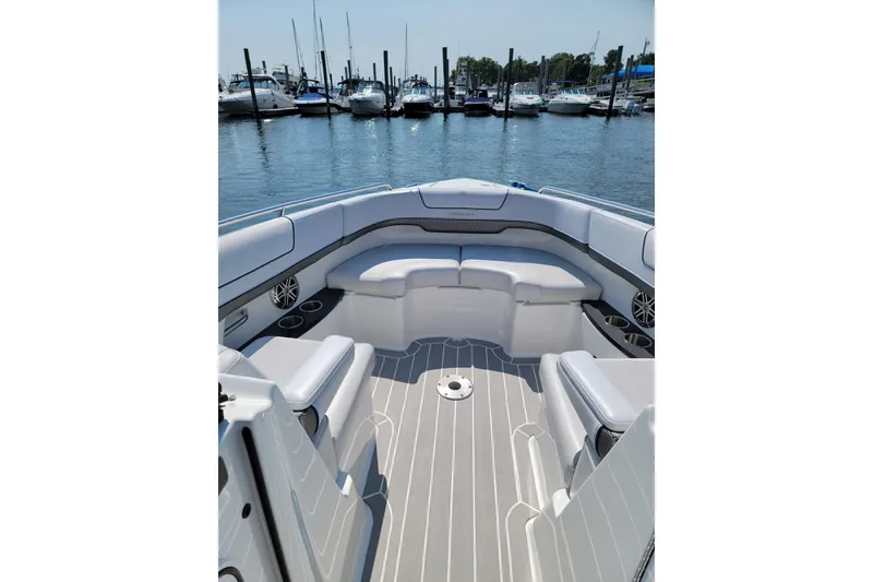 Slide: The Image of 2016 Formula 310 Bowrider interior with spacious seating, docked at a marina. - 15