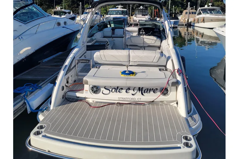 Slide: The Image of 2016 Formula 310 Bowrider docked, featuring spacious seating and sleek design. - 16