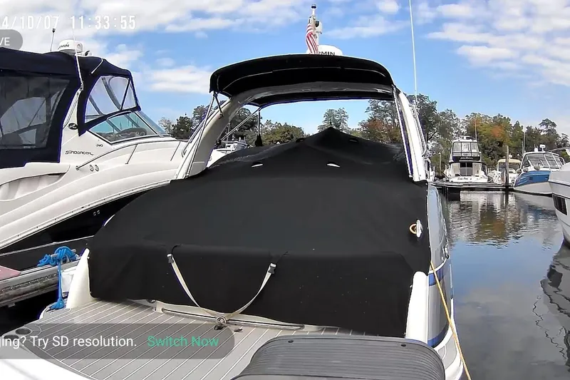 Slide: The Image of 2016 Formula 310 Bowrider docked at marina, covered with black tarp, surrounded by other boats. - 17