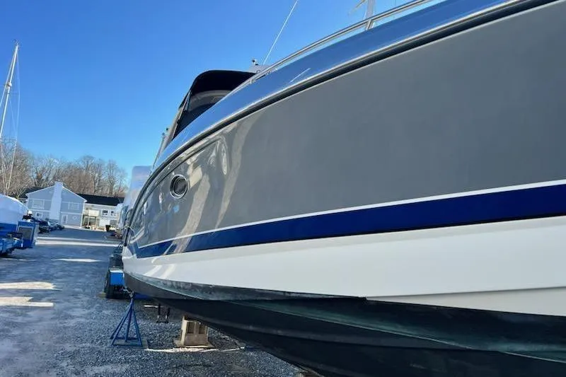 Slide: The Image of 2016 Formula 310 Bowrider boat on dry dock, showcasing sleek design and blue accents. - 18