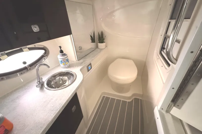 Slide: The Image of 2016 Formula 310 Bowrider bathroom with sink, toilet, and modern fixtures. - 28