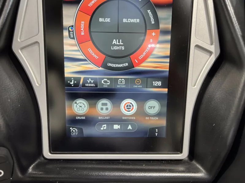Slide: The Image of 2021 Tigé 25ZX touchscreen control panel with various boat options. - 28