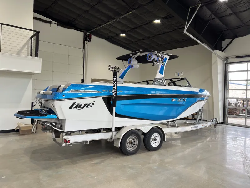 Slide: The Image of 2021 Tigé 25ZX boat on a trailer in a showroom. - 3