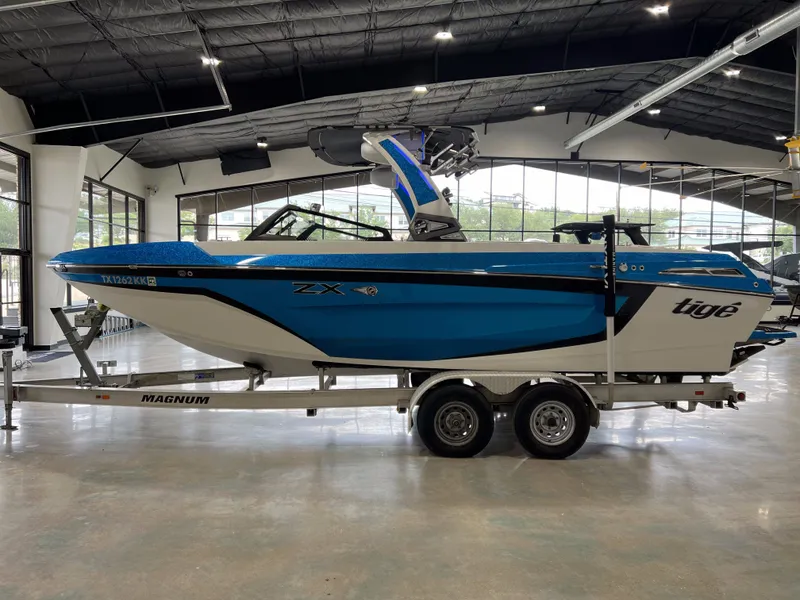 Slide: The Image of 2021 Tigé 25ZX boat in showroom on trailer. - 5