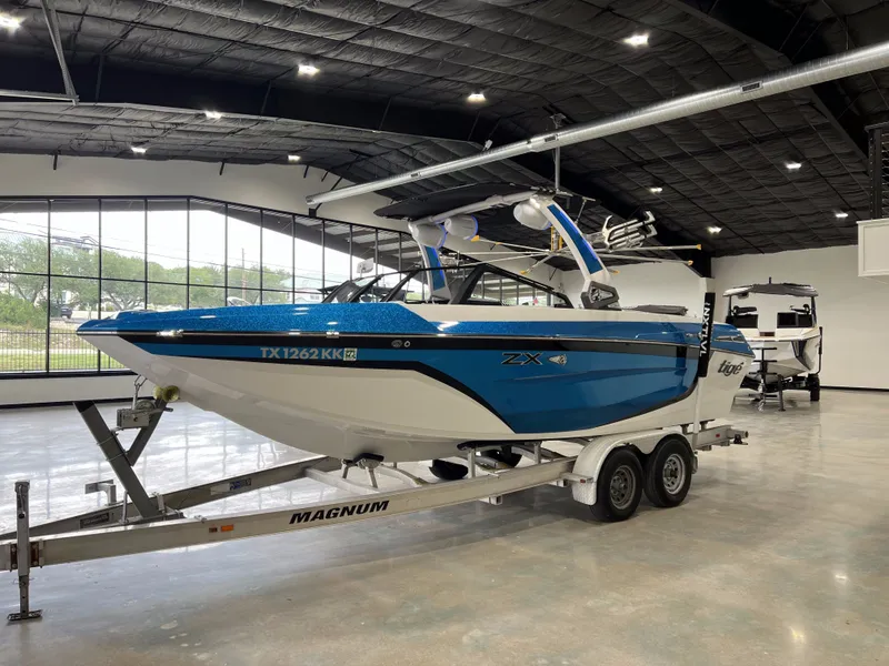 Slide: The Image of 2021 Tigé 25ZX boat on trailer in showroom. - 6