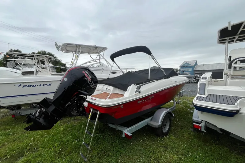 The Image of 2024 Bayliner VR4 Bowrider OB with outboard motor on trailer, parked outdoors. - 0