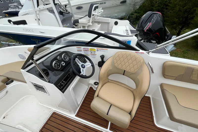 Slide: The Image of 2024 Bayliner VR4 Bowrider OB interior with steering wheel and seating. - 4
