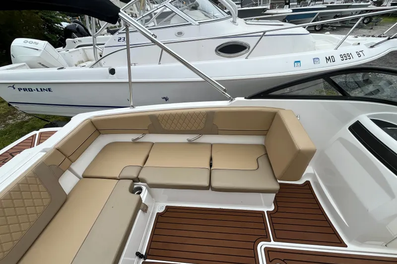 Slide: The Image of 2024 Bayliner VR4 Bowrider OB with tan seating and wood-style flooring. - 6