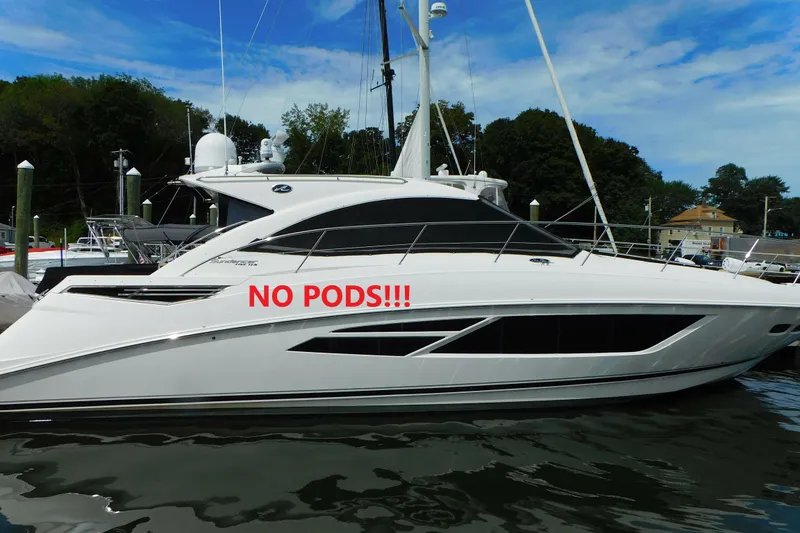 Slide: The Image of 2013 Sea Ray 510 Sundancer yacht docked, featuring "NO PODS!!!" text on the side. - 1