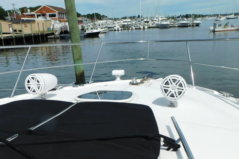 Slide: The Image of 2013 Sea Ray 510 Sundancer yacht bow with speakers, docked in a marina. - 12