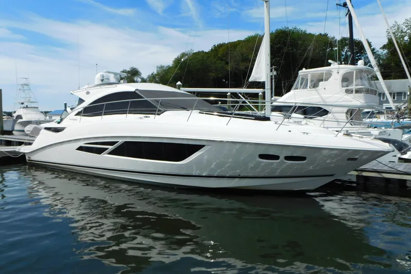 Slide: The Image of 2013 Sea Ray 510 Sundancer yacht docked at marina, reflecting on water. - 4