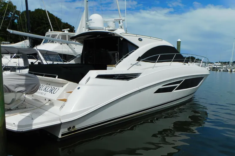 Slide: The Image of 2013 Sea Ray 510 Sundancer yacht docked in a marina under a blue sky. - 5
