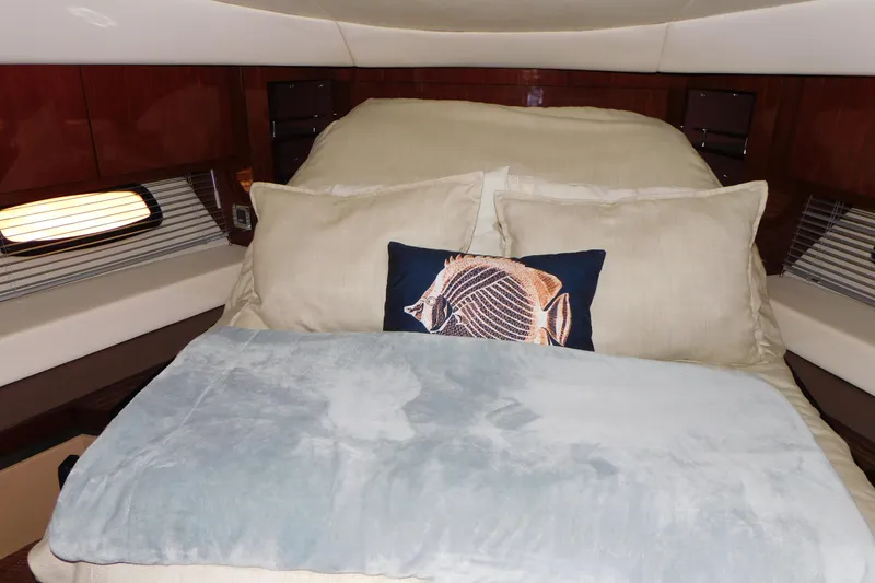 Slide: The Image of Luxurious 2013 Sea Ray 510 Sundancer cabin with plush bedding and decorative pillows. - 53