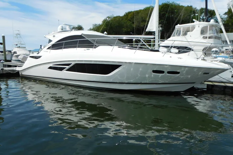 Slide: The Image of 2013 Sea Ray 510 Sundancer yacht docked at marina, reflecting on water. - 7