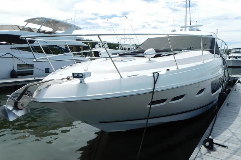 Slide: The Image of 2013 Sea Ray 510 Sundancer yacht docked at marina, sleek design, white exterior. - 8
