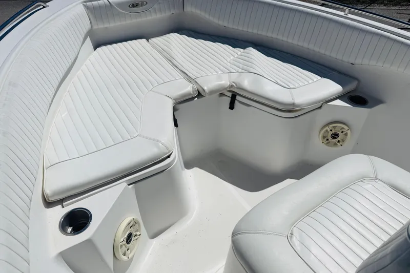 Slide: The Image of 2008 Sea Hunt Ultra 210 boat interior with white cushioned seating and cup holders. - 3