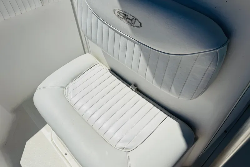 Slide: The Image of White cushioned seat on 2008 Sea Hunt Ultra 210 boat, featuring vertical stitching. - 4