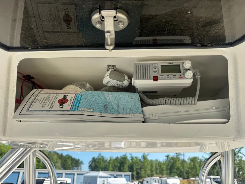 Slide: The Image of Bulls Bay 230 Center Console 2024 with radio and nautical charts. - 12