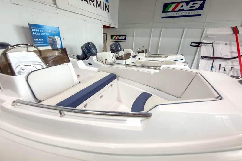 Slide: The Image of 2023 AB Inflatables Nautilus 13 boat interior with seating and control panel in showroom. - 21