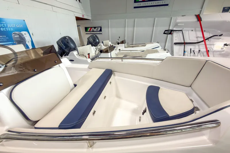 Slide: The Image of 2023 AB Inflatables Nautilus 13 boat interior with cushioned seating and Yamaha engines. - 22