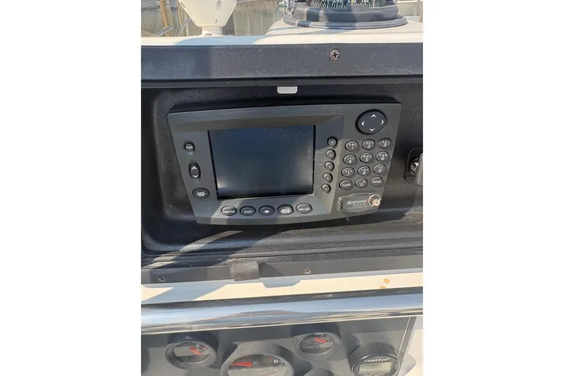 Slide: The Image of 1993 Boston Whaler 21 Outrage dashboard with navigation system and gauges. - 10