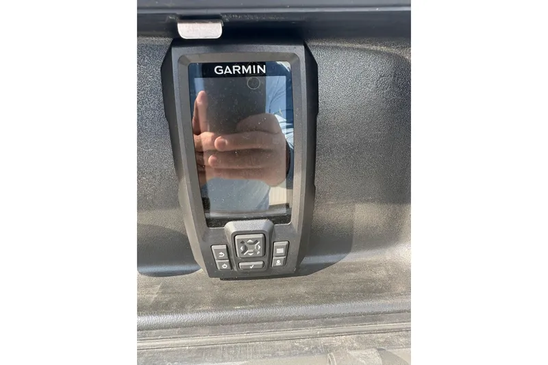 Slide: The Image of Garmin device on a 1993 Boston Whaler 21 Outrage boat dashboard. - 11