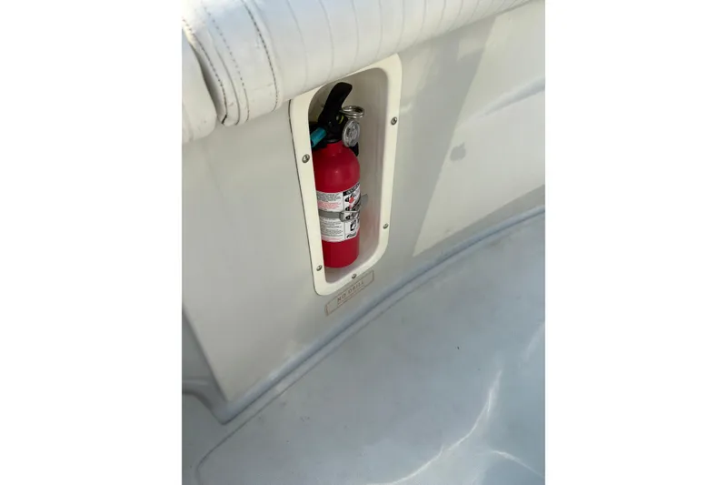 Slide: The Image of Fire extinguisher mounted on a 1993 Boston Whaler 21 Outrage boat interior. - 15