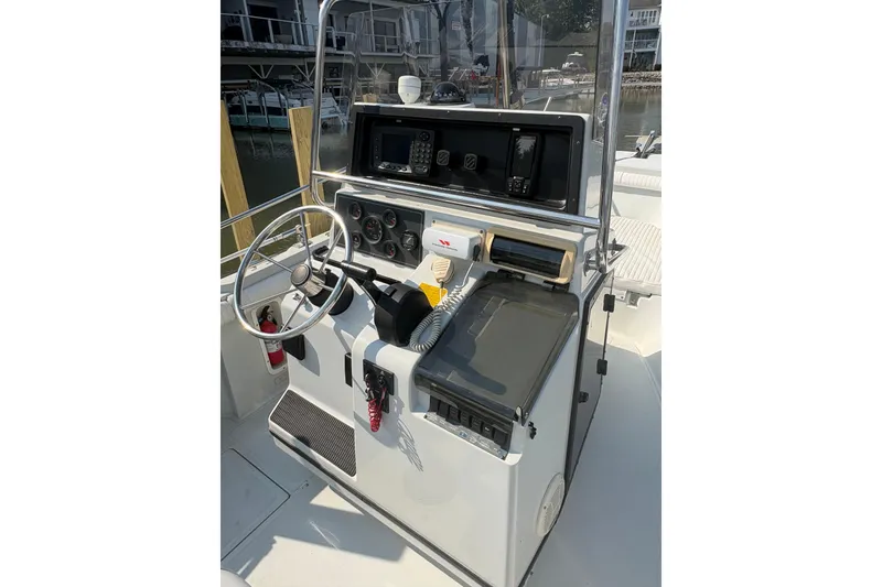Slide: The Image of 1993 Boston Whaler 21 Outrage boat console with steering wheel and navigation equipment. - 6