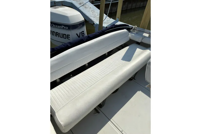 Slide: The Image of 1993 Boston Whaler 21 Outrage boat with white seating and Evinrude V6 engine. - 8