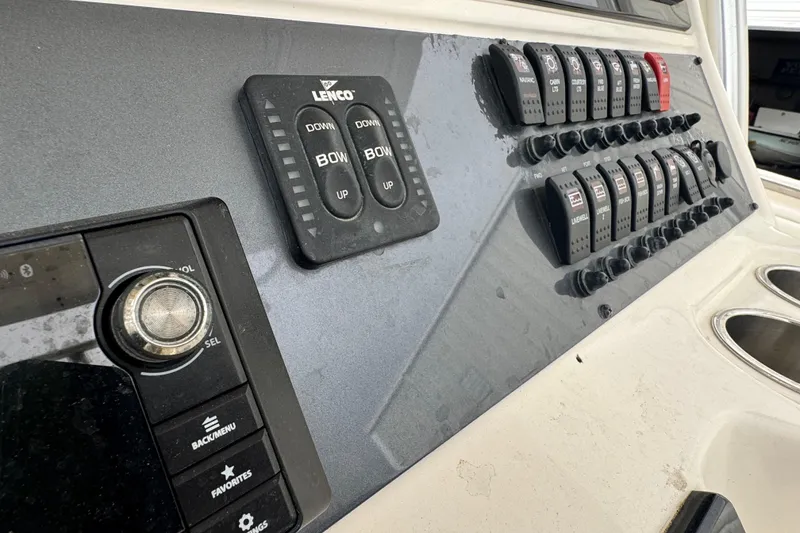 Slide: The Image of 2007 Robalo R300 Center Console dashboard with control switches and Lenco trim tab panel. - 10