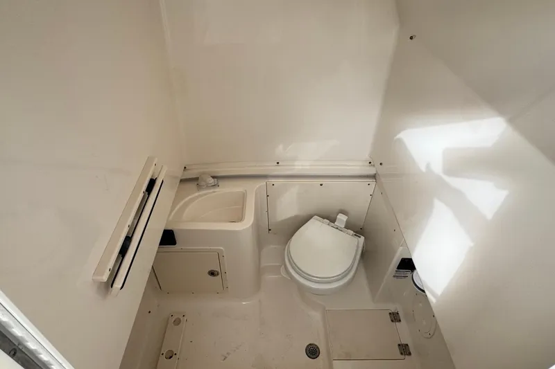 Slide: The Image of 2007 Robalo R300 Center Console boat interior with toilet and sink. - 12