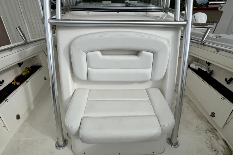 Slide: The Image of 2007 Robalo R300 Center Console boat seat with white upholstery and stainless steel frame. - 13