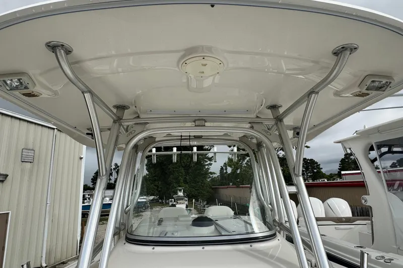 Slide: The Image of 2007 Robalo R300 Center Console boat with sturdy T-top and rod holders. - 14